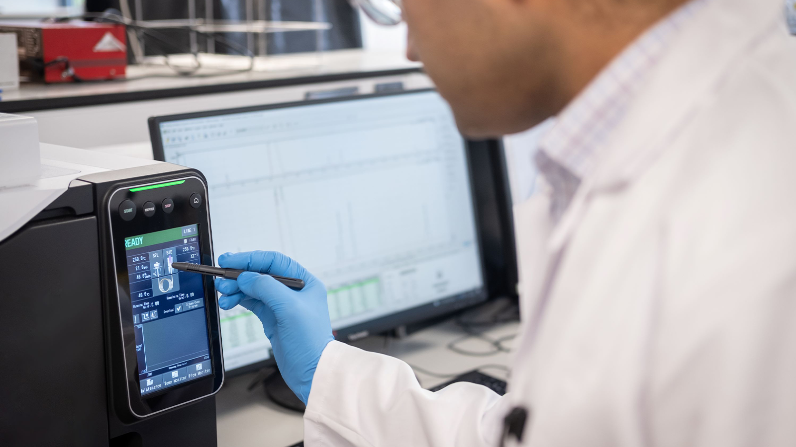 UKRI Interdisciplinary Centre for Circular Chemical Economy team member in a lab coat using a touch screen device for their work